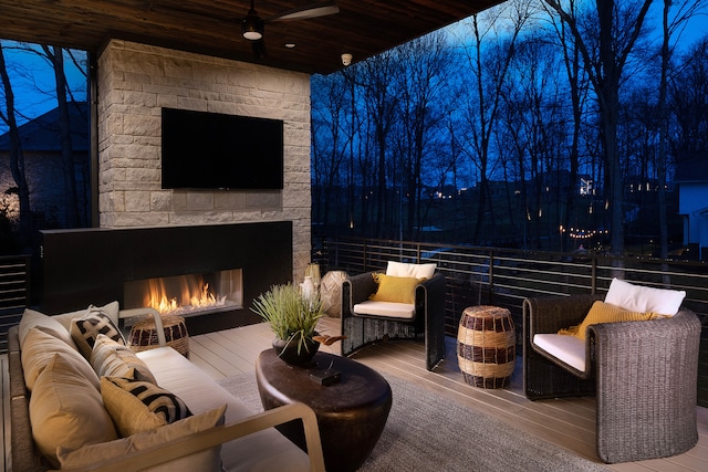 patio terrace at twilight with an outdoor living space with a fireplace