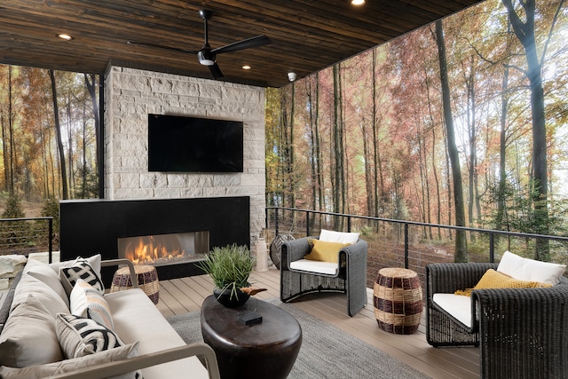 wooden deck featuring an outdoor living space with a fireplace