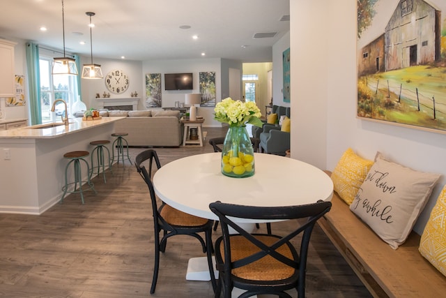 dining area featuring dark hardwood / wood-style flooring and sink