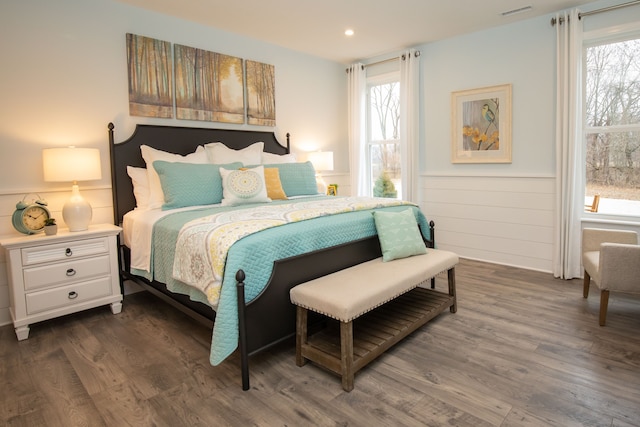 bedroom with dark hardwood / wood-style floors