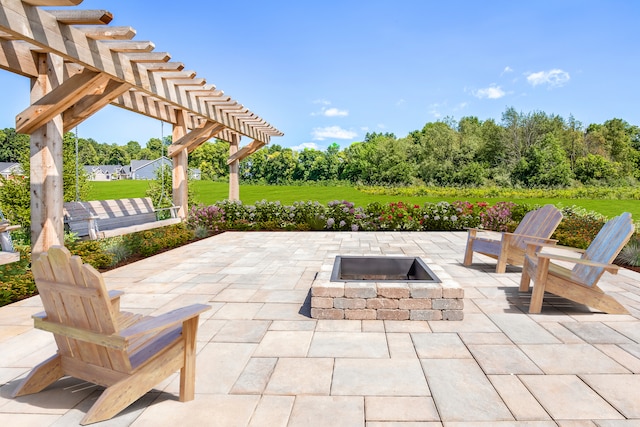 view of patio with a pergola and a fire pit