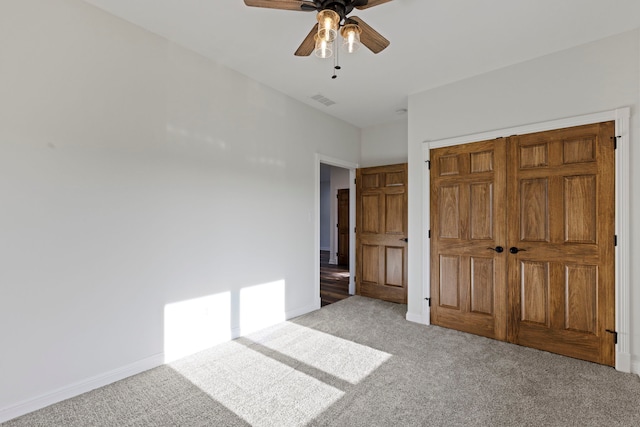 unfurnished bedroom featuring a closet, ceiling fan, and carpet flooring