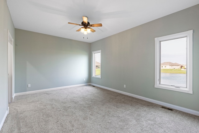 empty room featuring carpet and ceiling fan