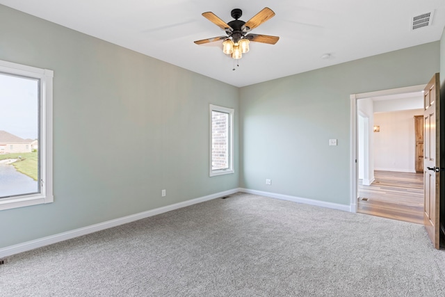 empty room with carpet and ceiling fan