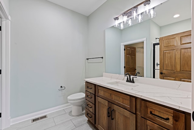 bathroom featuring toilet, tile floors, and vanity