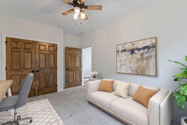 home office with ceiling fan and carpet