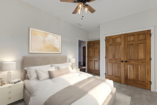 bedroom with a closet, ceiling fan, and carpet floors