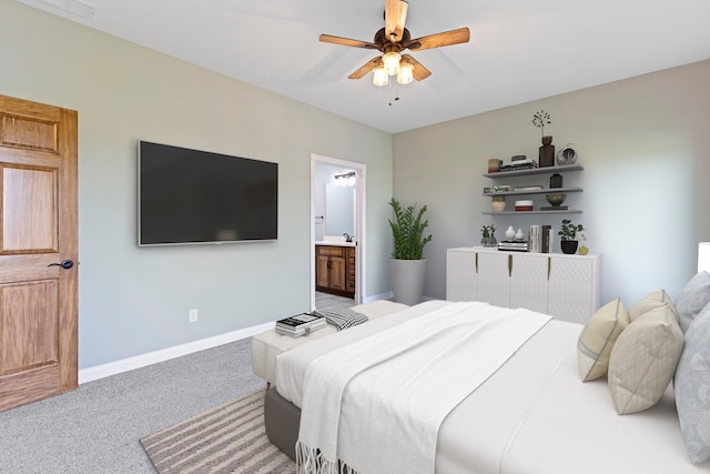 carpeted bedroom featuring ceiling fan and connected bathroom