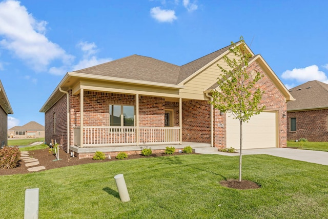 view of front facade featuring a front lawn, covered porch, and a garage