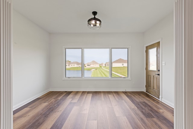 empty room with dark hardwood / wood-style flooring