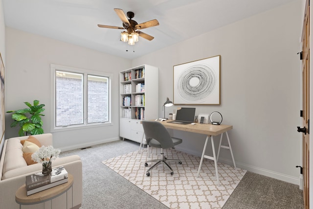 carpeted office with ceiling fan