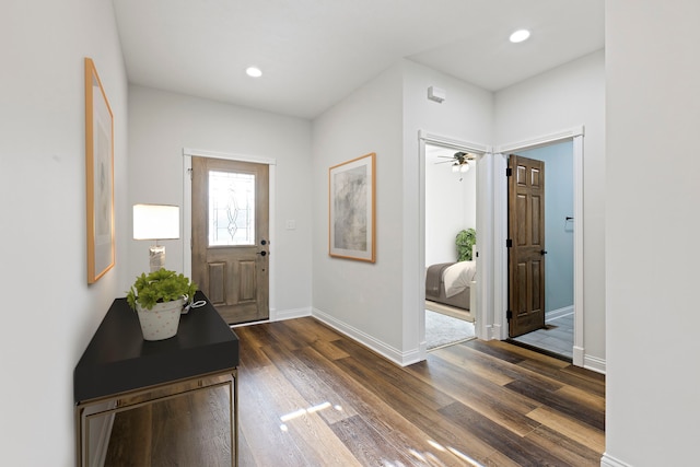 foyer with dark hardwood / wood-style floors and ceiling fan