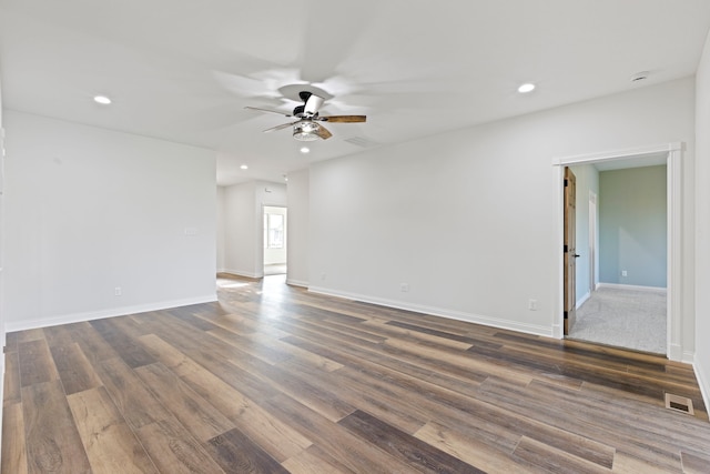 spare room featuring dark hardwood / wood-style flooring and ceiling fan