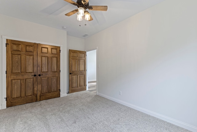 unfurnished bedroom with a closet, ceiling fan, and carpet