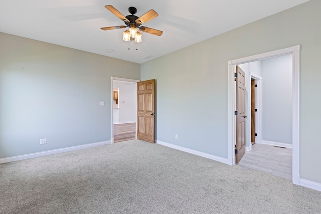 unfurnished bedroom with light carpet and ceiling fan