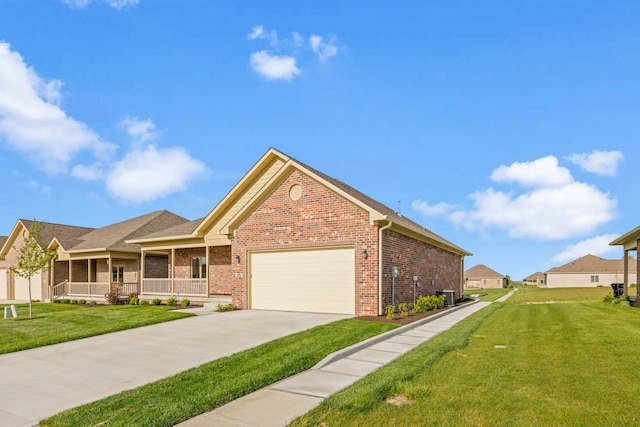 view of front facade with a front lawn, covered porch, a garage, and central AC