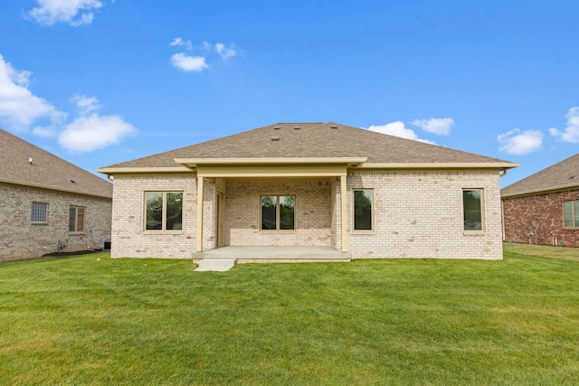 back of property with a patio and a yard