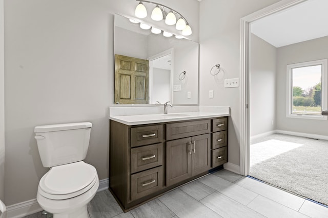 bathroom featuring vanity, toilet, and tile floors