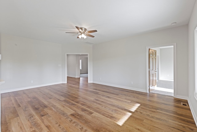 spare room with wood-type flooring and ceiling fan