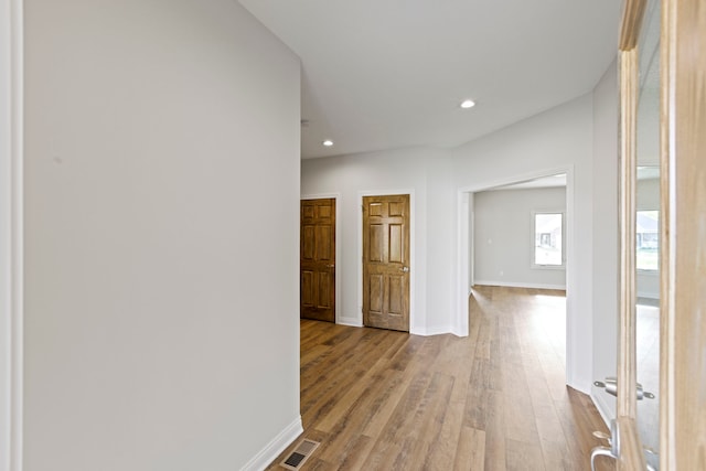 corridor featuring hardwood / wood-style floors