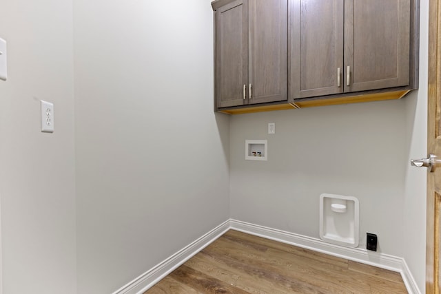 washroom featuring hardwood / wood-style floors, electric dryer hookup, cabinets, and hookup for a washing machine