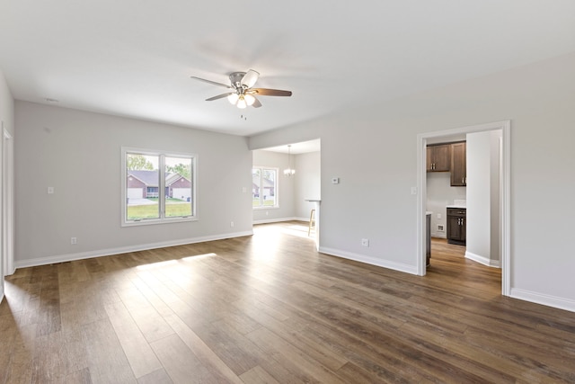 spare room with ceiling fan and dark hardwood / wood-style floors