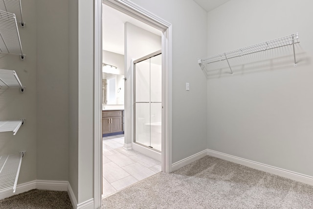 spacious closet with light tile floors