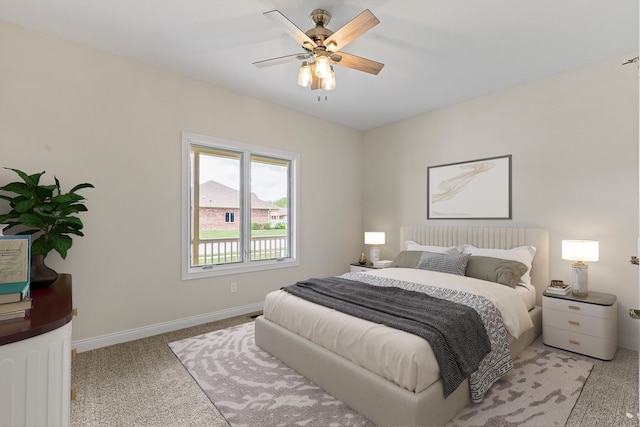 bedroom featuring light carpet and ceiling fan