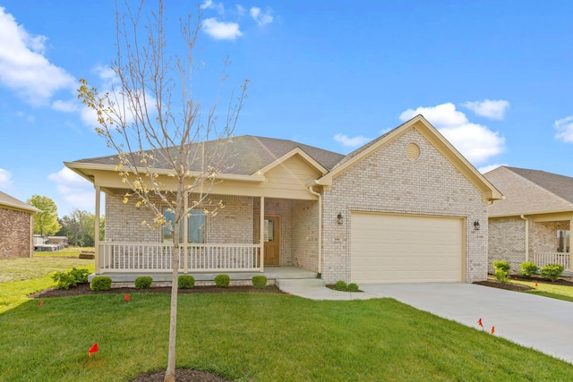 ranch-style home featuring a front lawn, covered porch, and a garage