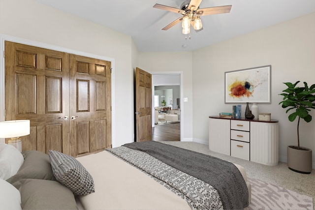 carpeted bedroom with a closet and ceiling fan