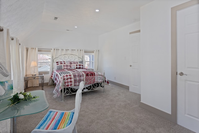 bedroom featuring light carpet, lofted ceiling, and multiple windows