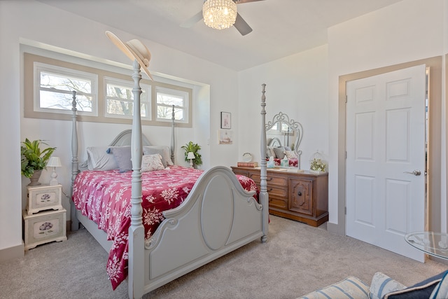 carpeted bedroom with ceiling fan and multiple windows