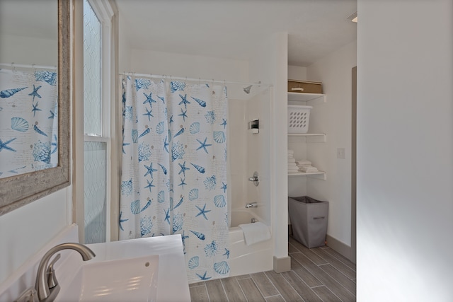 bathroom with shower / tub combo and sink