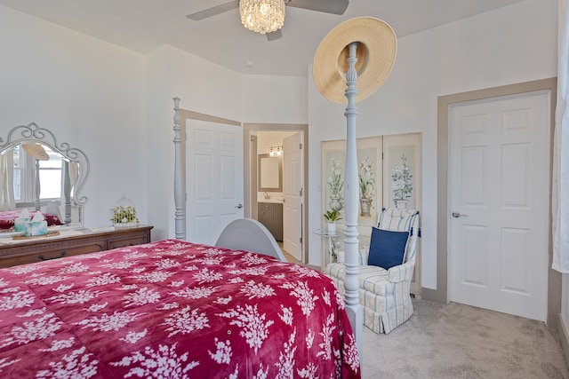 bedroom with ensuite bath, ceiling fan, and light colored carpet