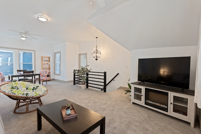 living room with light carpet, vaulted ceiling, and ceiling fan with notable chandelier