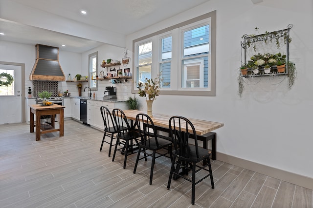 dining area with light wood-type flooring and sink