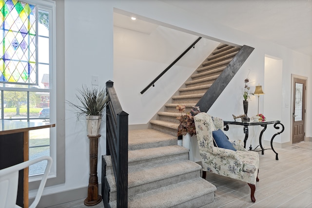 staircase with light hardwood / wood-style flooring