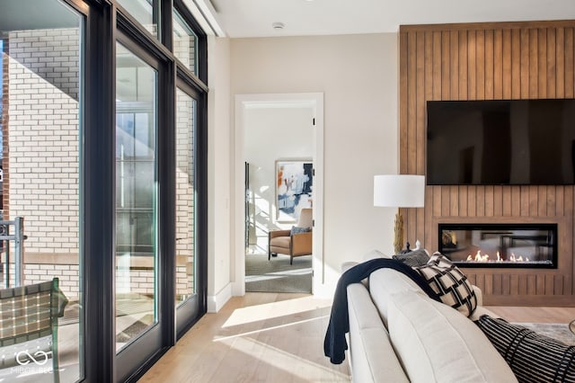 bedroom featuring a fireplace, light hardwood / wood-style floors, and access to exterior