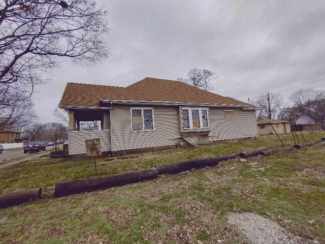 view of side of home with a yard