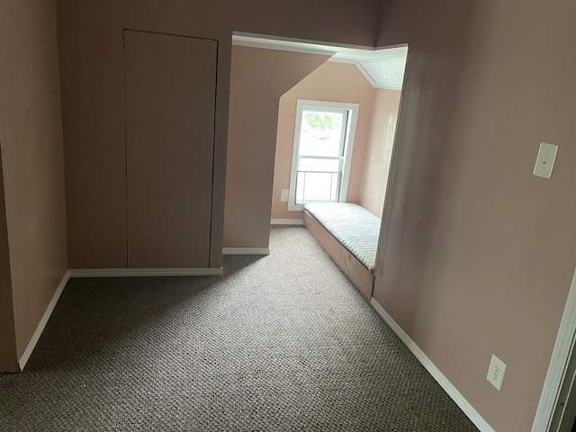 hall with light colored carpet and vaulted ceiling