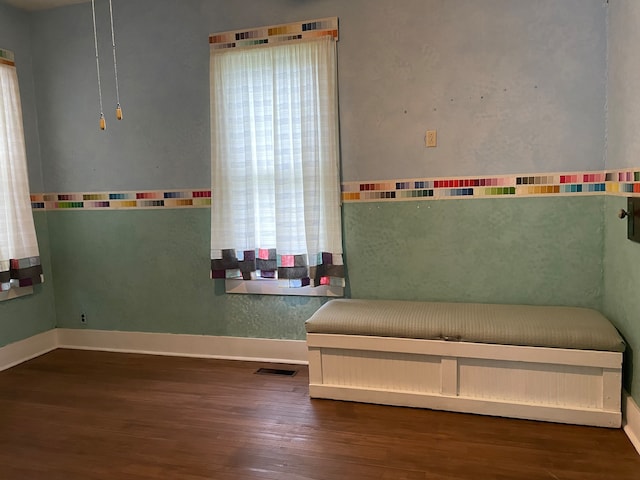 unfurnished bedroom with dark wood-type flooring