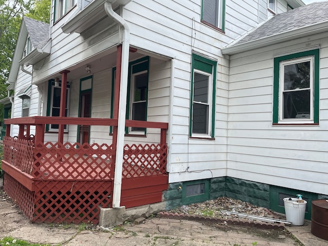 view of property exterior featuring a wooden deck