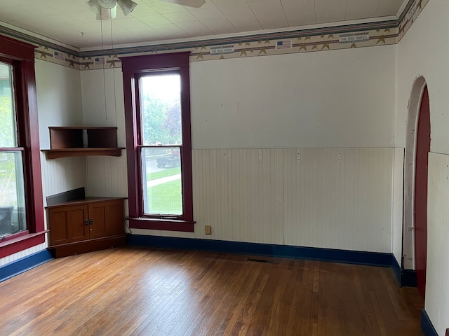 empty room with ceiling fan and dark hardwood / wood-style floors