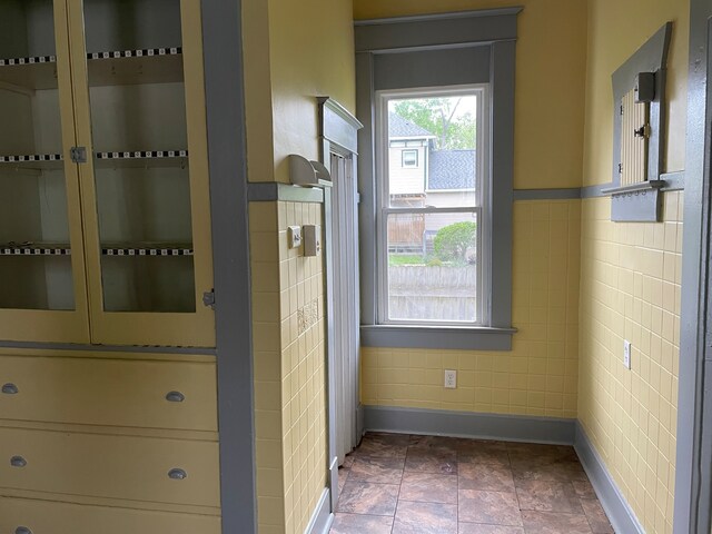 doorway to outside with dark tile floors