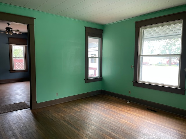 spare room featuring dark hardwood / wood-style flooring and ceiling fan