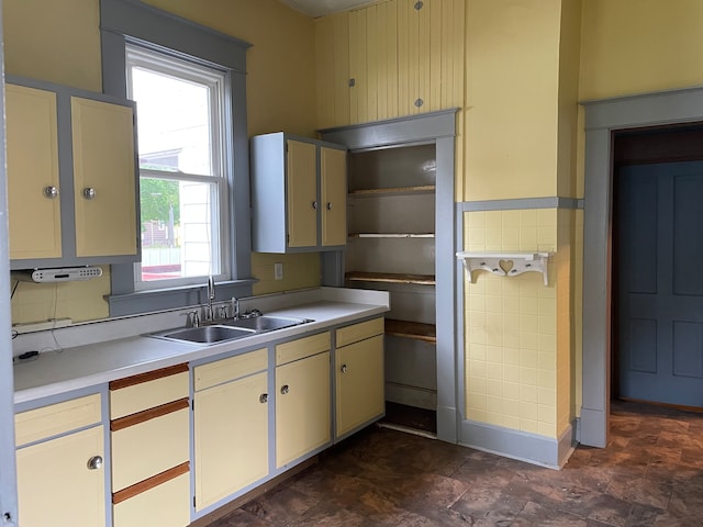 kitchen featuring dark tile flooring and sink