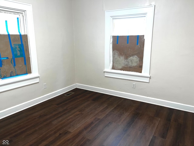 spare room featuring dark wood-type flooring