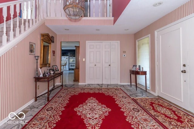 1205 Ivywood Ct, New Castle, IN 47362 - foyer entrance featuring wallpapered walls, a wealth of natural light, and baseboards