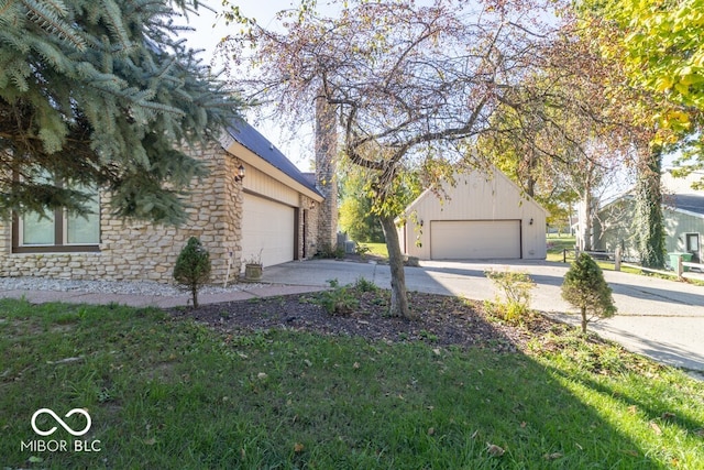 view of side of home with a garage and a lawn