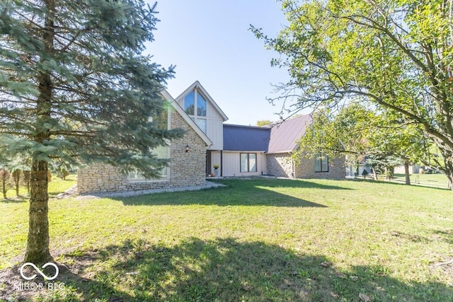 1205 Ivywood Ct, New Castle, IN 47362 - rear view of property featuring a lawn, metal roof, and stone siding